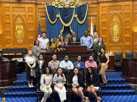 Odyssey Program students pictured with Massachusetts State Representative Russell E. Holmes in the State House. 