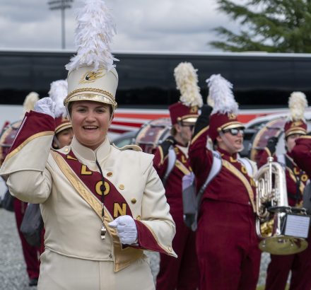 Mallory Poff is dressed in her drum major uniform leading the band on game day.