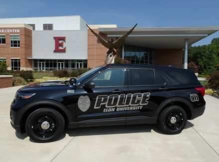 Elon University Campus Safety and Police vehicle in front of Schar Center.