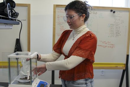 A student working with instruments in a science lab