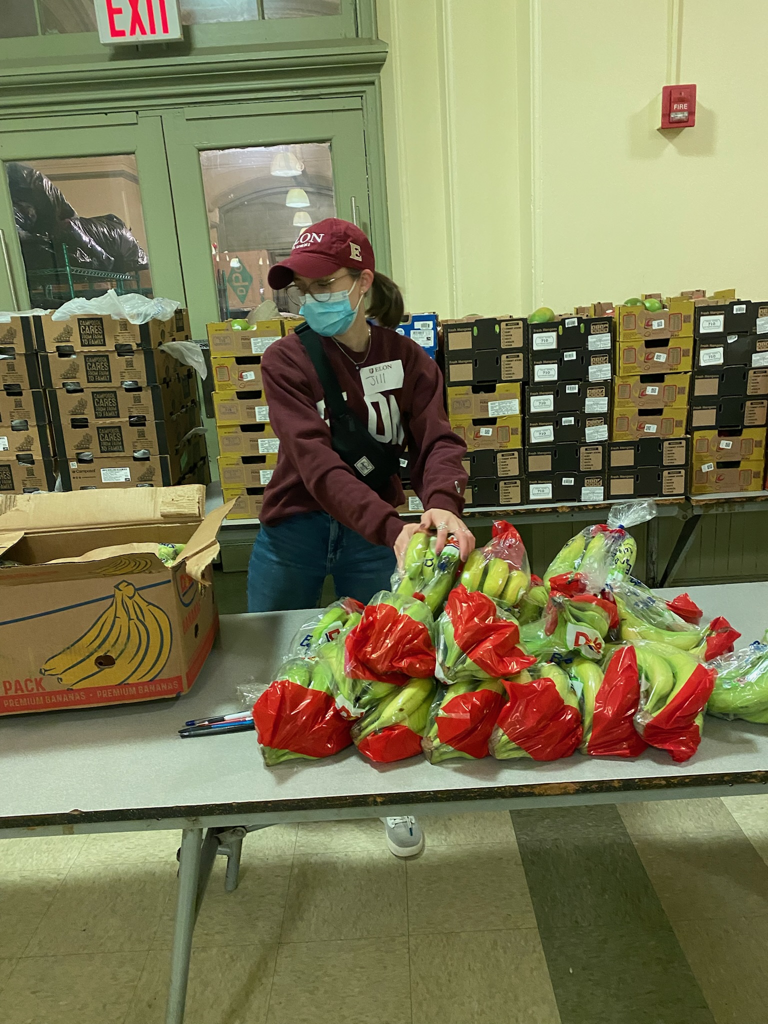 Elon alumni volunteer packing food. 