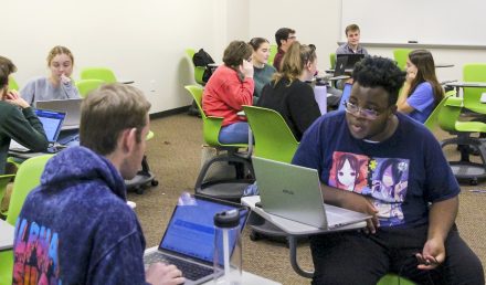 Students meeting in groups in a Lindner Hall classroom