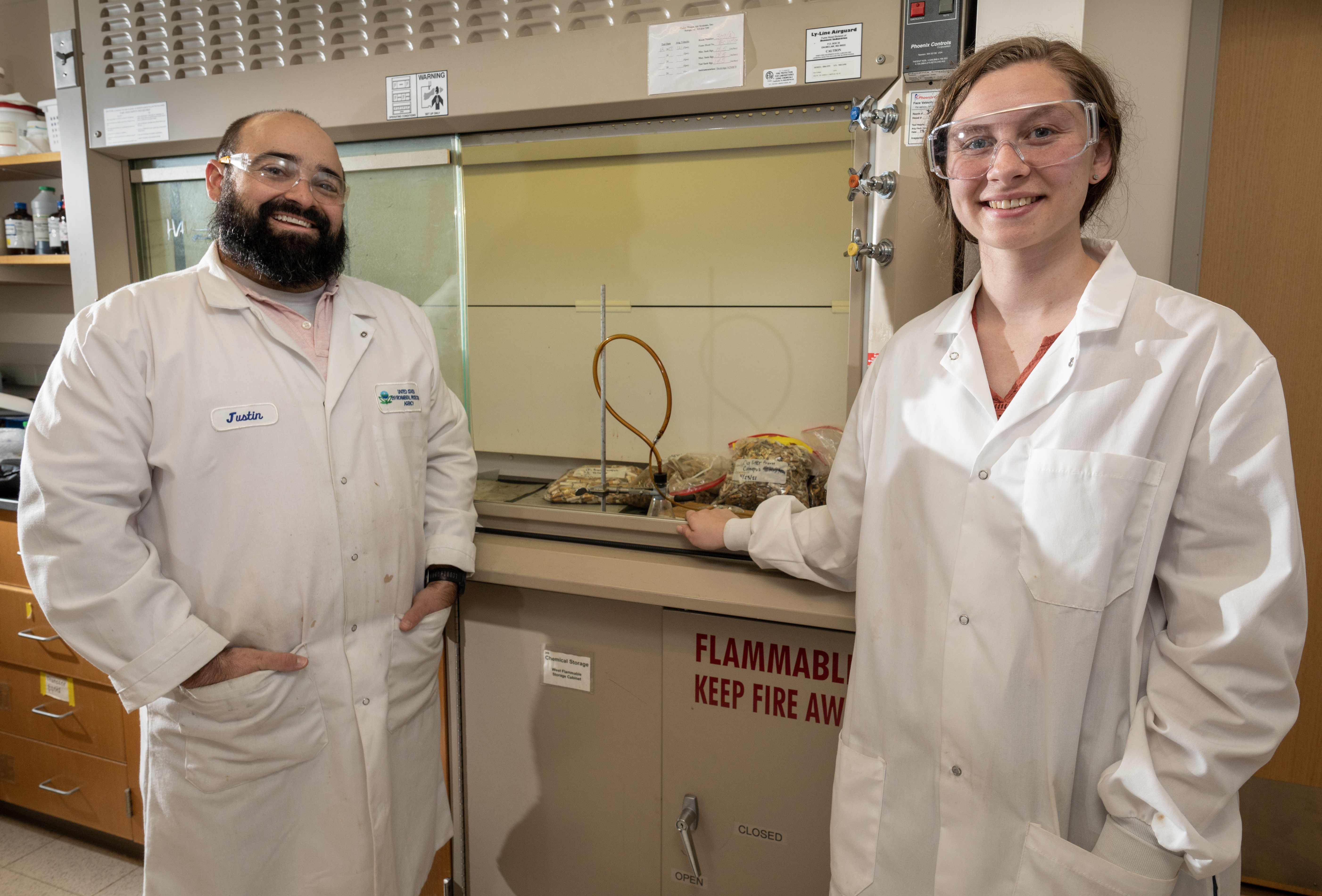 Chemistry professor Justin Clar and Anna Altmann pose for a photo in the lab