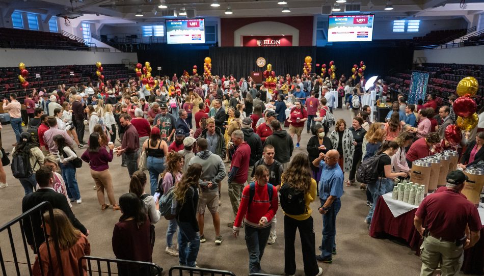 People gather at Elon Day College Coffee in Alumni Gym. 