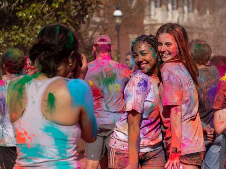 Students pose together during Holi celebration on Elon University's campus.