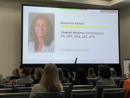 Video screen with image of Shefali Christopher as award winner