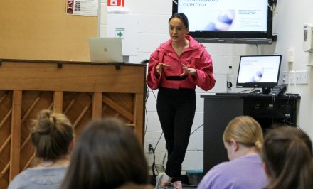 Colette Dong speaking in front of a group of students