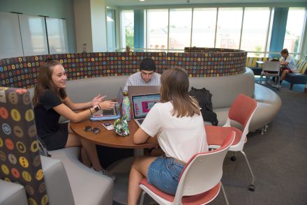Three students studying inside the Koenigsberger Learning Center at Elon University