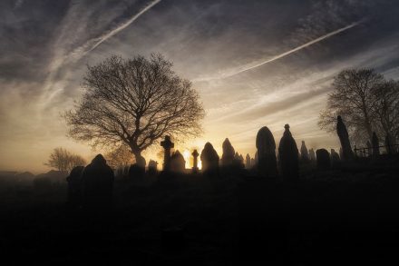 A spooky church graveyard on a misty Winter morning