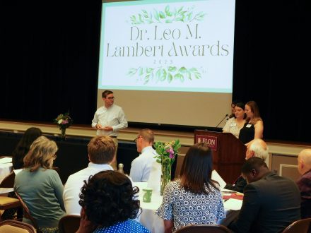 Alexis Swider, assistant director of Student Involvement for fraternities and sororities, and Shannon Finney, assistant director of Student Involvement for student organization development presenting an award at the annual Leo M. Lambert Awards.
