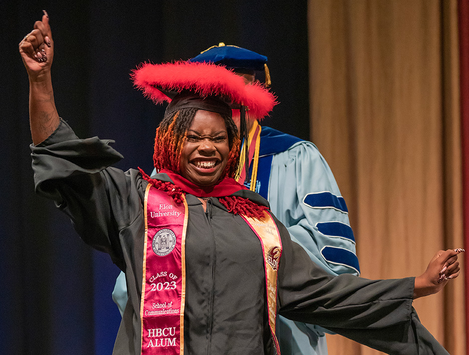 A master's-level graduate receives her hood during Commencement.