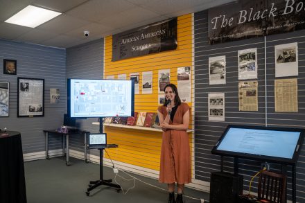 Lucy Garcia shows a map and screens of her research