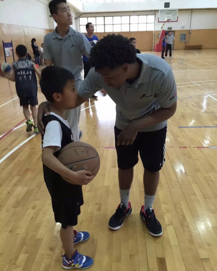 Smith coaches a young child at the program he worked with in China.