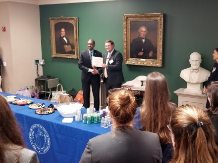 John Ferebee receives a certificate honoring his win in a moot court competition.
