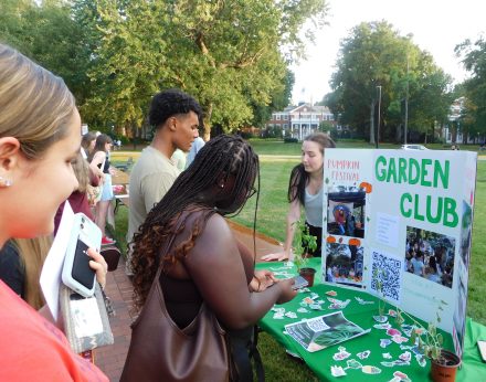 Students engaging with members of the Elon Community Garden club at the 2023 Fall Organization Fair. 