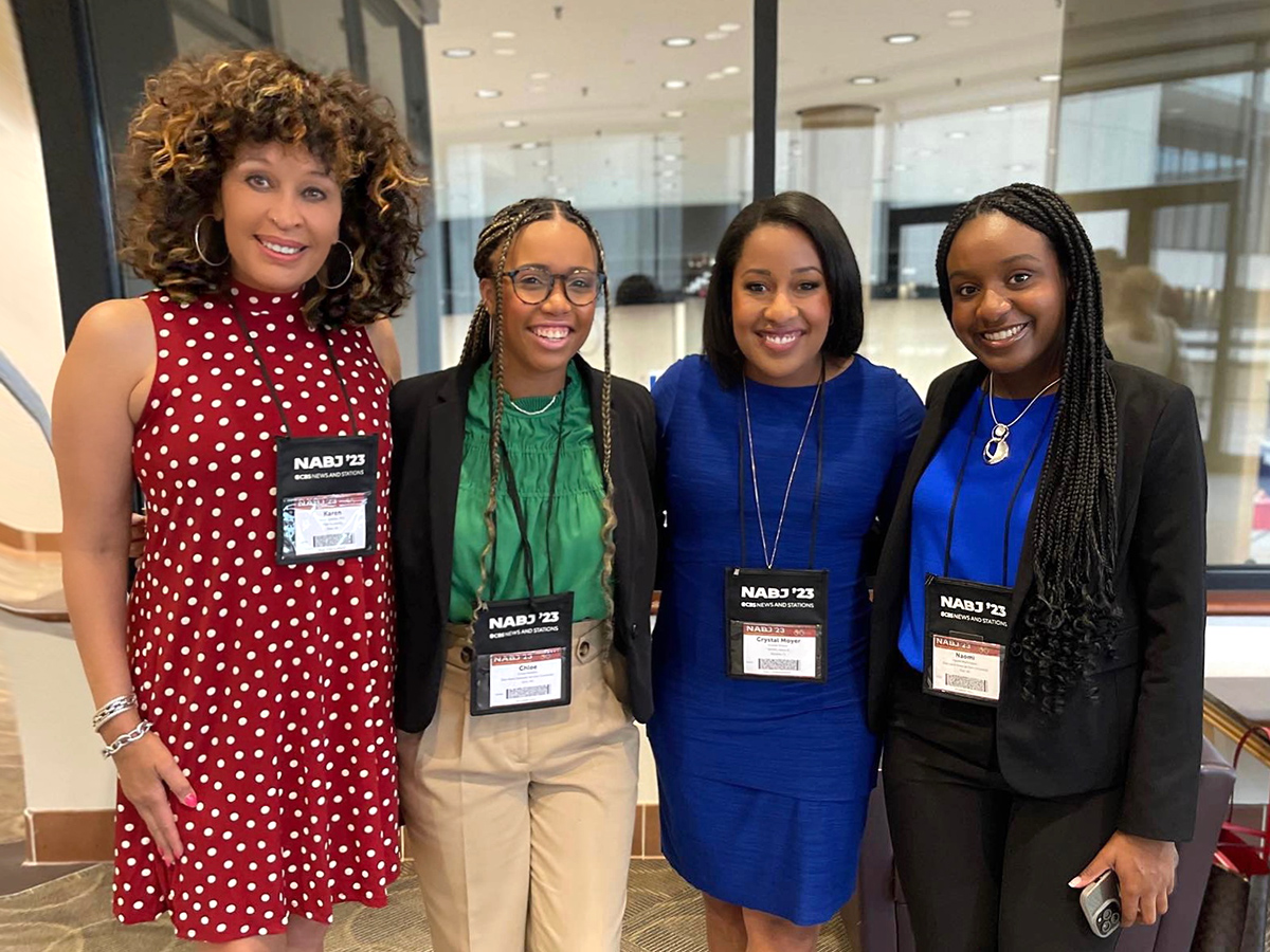Four Black women pose for photo at NABJ conference