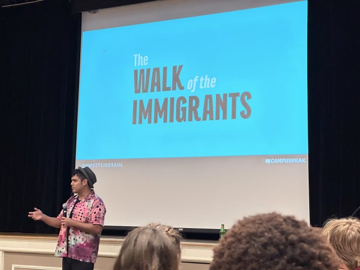Saul Flores delivering the keynote address at the 2023 Intersect Conference, introducing the Walk of the Immigrants project.