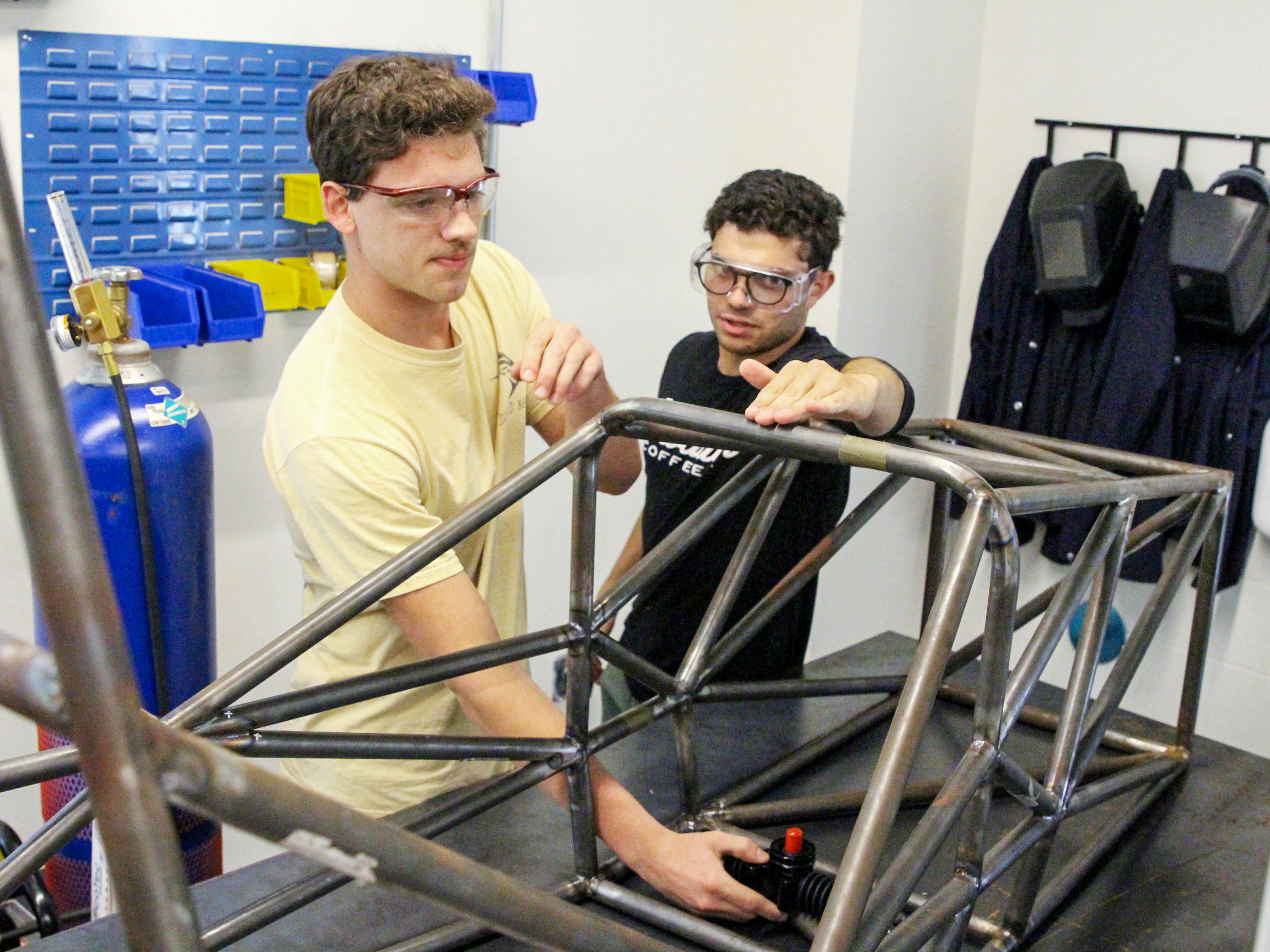 Two students with a vehicle frame