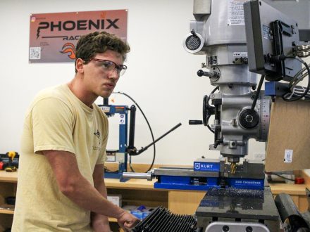 Nicholas Muller working with a large industrial machine