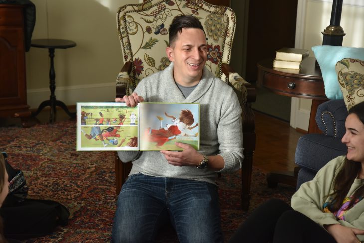 Assistant Professor of Education Nermin Vehabovic reading with his Children's Literature and Arts Integration course and the children the class works with.