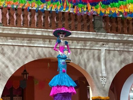 A statue of Day of the Dead woman in colorful dress.
