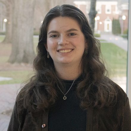 Avery Sloan, journalism major at Elon University, smiles in Snow Family Grand Atrium.