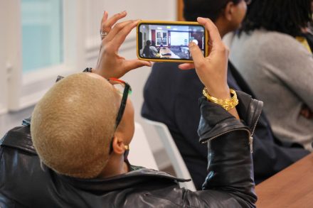 An attendee taking a photo during an educational session at the Black Solidarity Conference, Friday, Feb. 23.