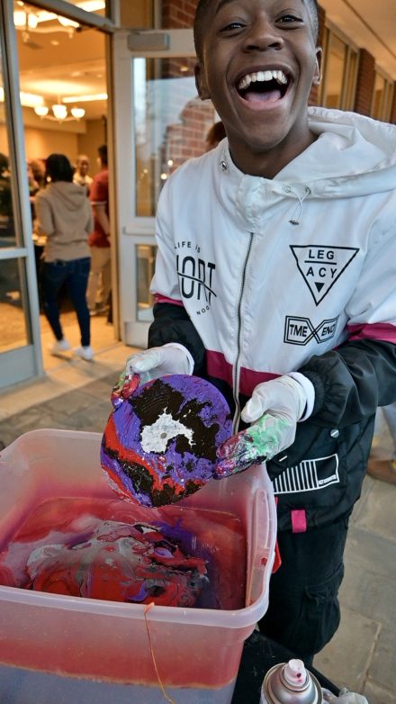 Kashawn Myer'26, student coordinator for Black Student Success within the CREDE, paint dipping vinyl at the Black History Month kickoff event on February 1, 2024. 