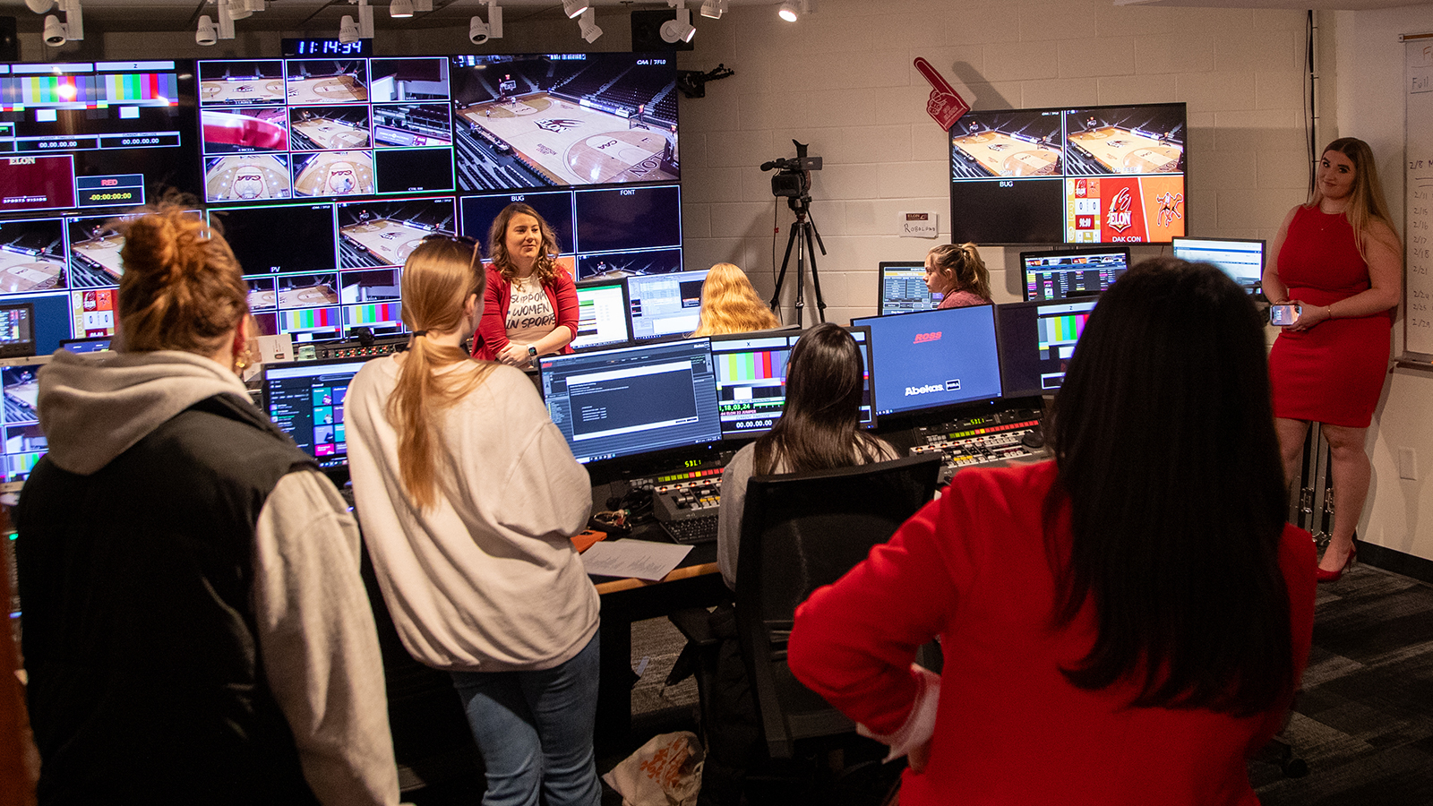 A group of women gather in the Elon Sports Vision control room in Schar Center.