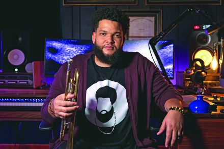 Kris Johnson in a music studio with his trumpet