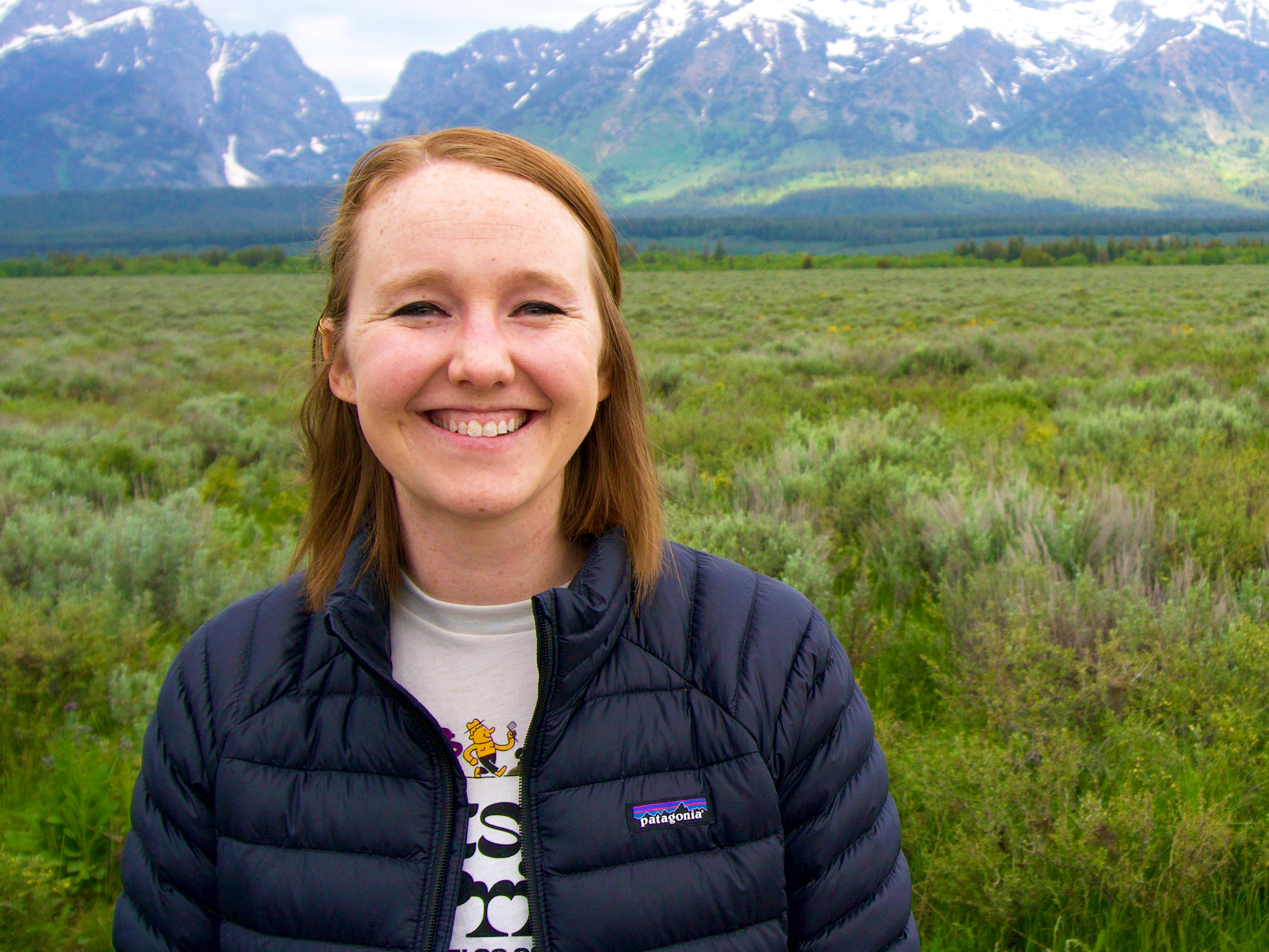 Portrait of Amber Smith '14 in front of a snow-capped mountain range