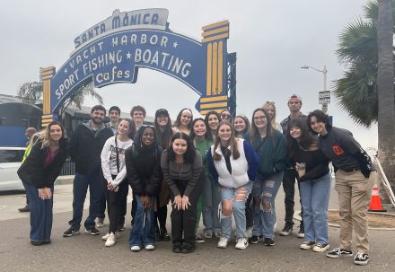 Elon University students pose at the Santa Monica pier sign.