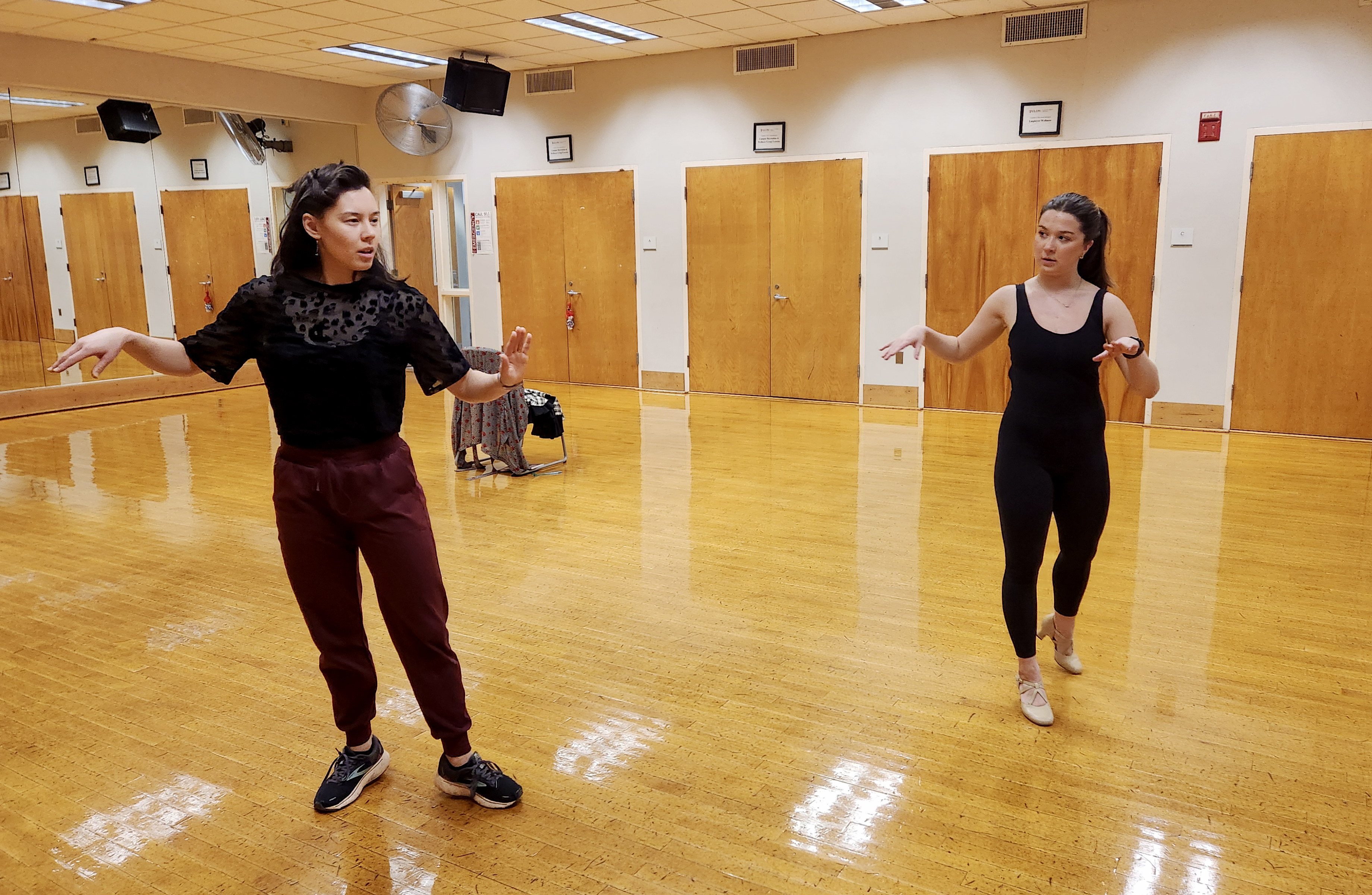 A student and professor rehearse in a dance studio