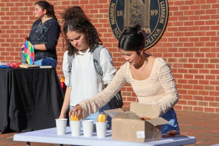Students setting up a station at the API Heritage Month kickoff on Wednesday, April 3.
