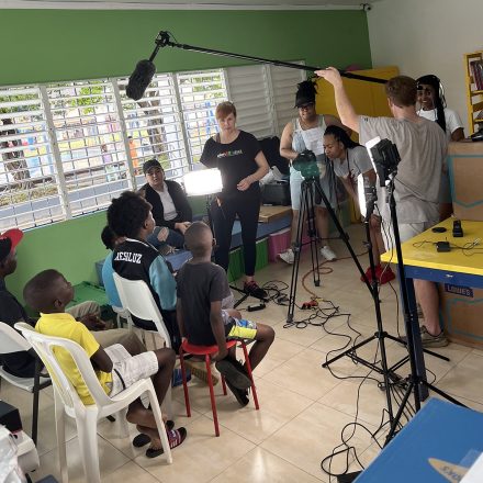 A group of Elon students hold recording equipment while in the Dominican Republic.