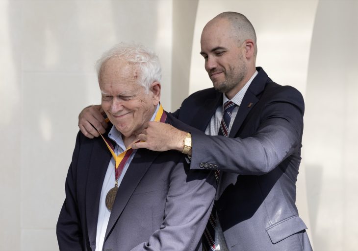 Jeremy Allen '07 places the Elon Medallion around the neck of his father, Trustee Noel Allen '69, at the Elon Medallion ceremony on Friday, April 19, 2024.