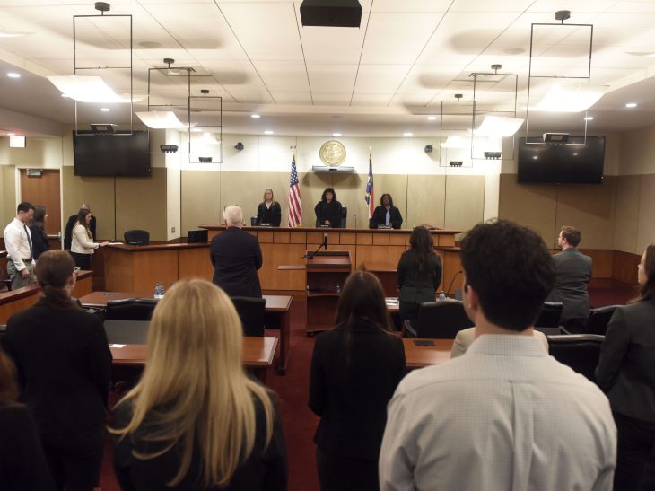 Students and attorneys stand for North Carolina Court of Appeals Judges Julee Flood, April Wood, and Carolyn Thompson shortly before the start of oral arguments on April 9, 2024, in Brown v. Caruso Homes, Inc.