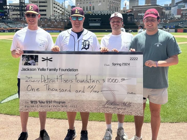 Scott Yelle P'24, second from left, with Elon Club Baseball teammates of his son, Jackson, during a check presentation at Comerica Park in Detroit. (Courtesy of the Jackson Yelle Family Foundation)