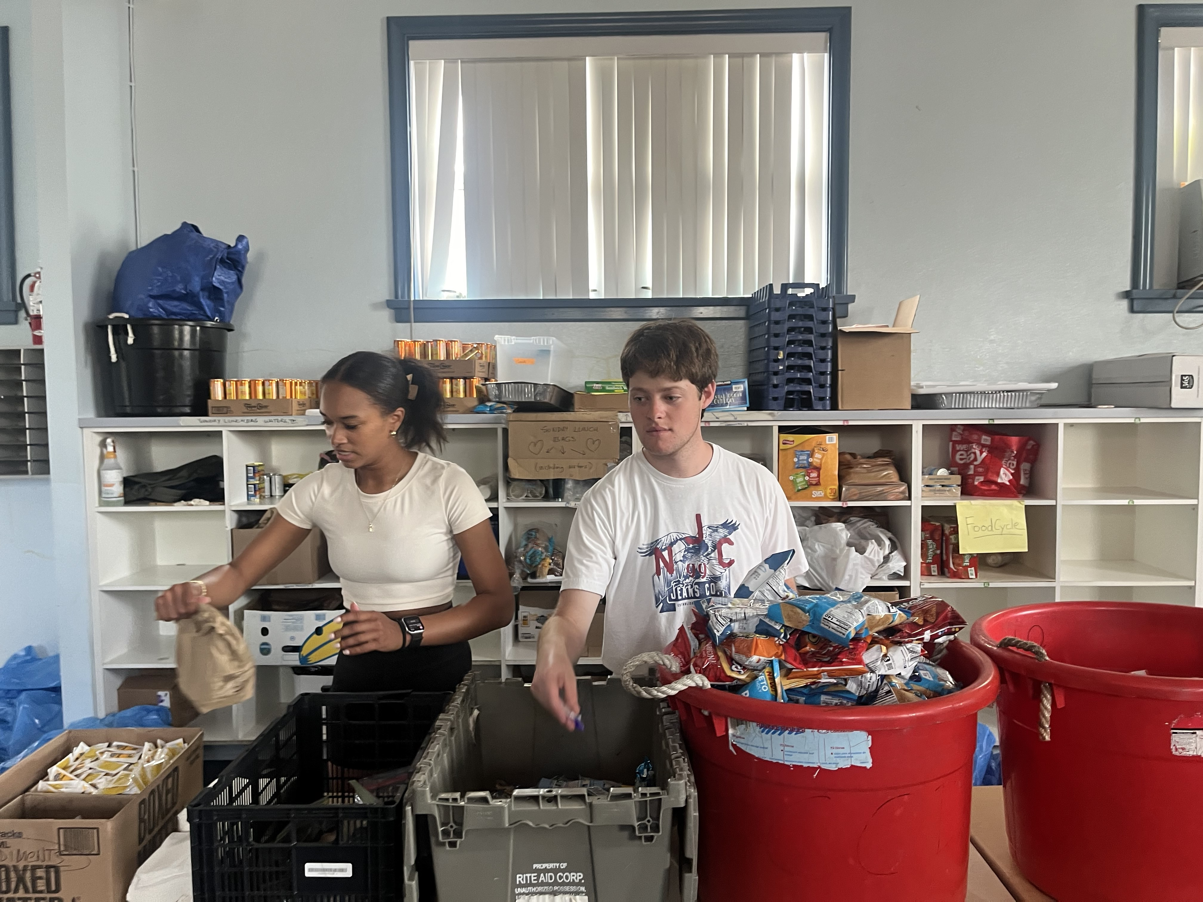 Two people work at a food bank