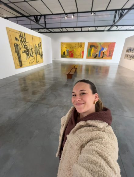 Andrea Baca takes a selfie in front of art in the Museum of Contemporary Art