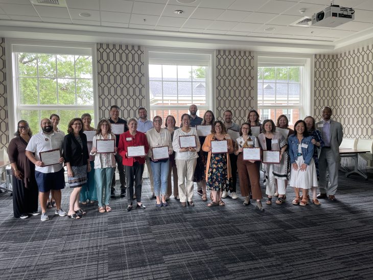 Group of people hold certificates 