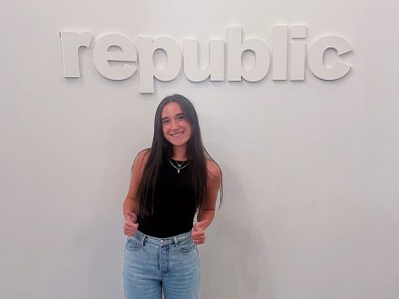 Nicole Bazos smiles in front of Republic sign