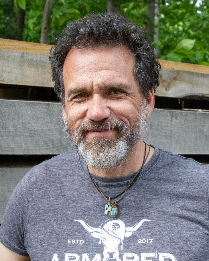 Headshot of a bearded man at a construction site