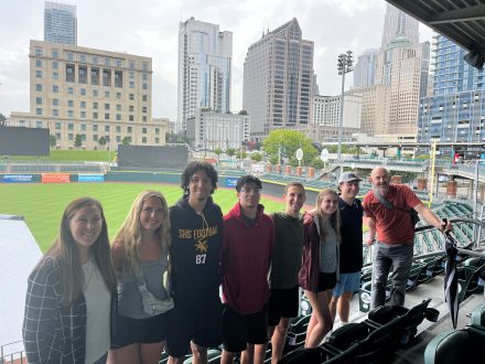 Elon students pose for a photo in Truist Field