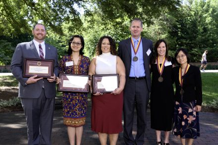 Six people pose for a photo.