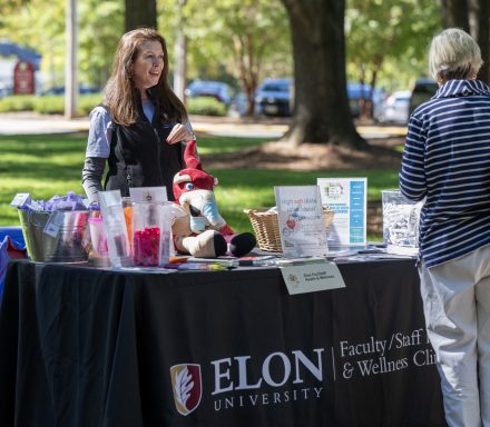 Sarah Parker, Family Nurse Practitioner at the Ellington Center for Health & Wellness shares information and swag at HealthEU day October 17, 2023, outside the Koury Center on the campus of Elon University.