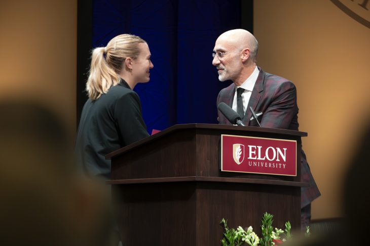 Arthur C. Brooks and Taylor Cote shake hands