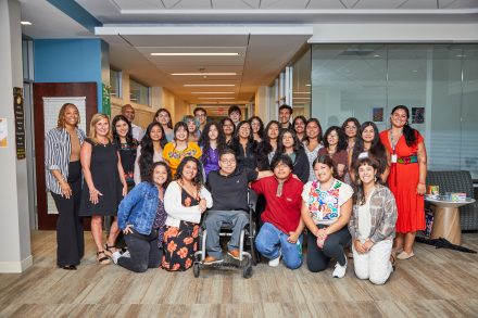 Group of people pose for photos