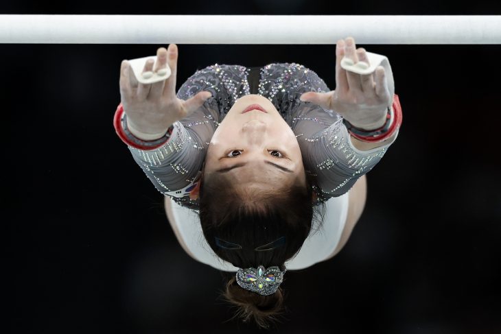 Sunisa Lee reaches for bars during gymnastic event