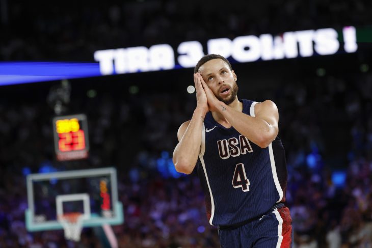 Steph Curry puts his hands beside his face